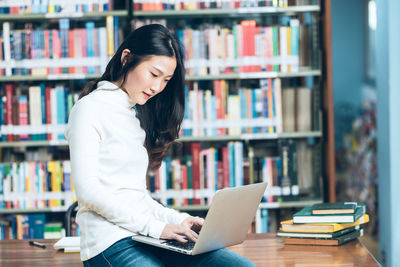 Full length of woman reading book