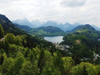 Scenic view of river and mountains against sky