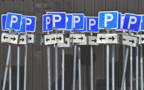 Parking sign boards against corrugated iron