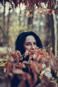 Portrait of woman holding plant