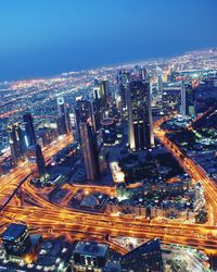 High angle view of city lit up at night