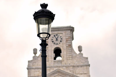 Low angle view of street light against building