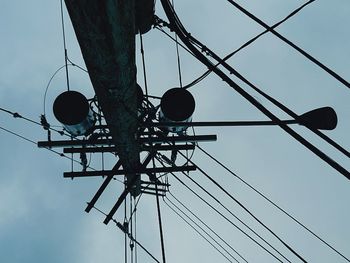 Low angle view of electricity pylon against sky