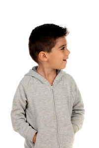 Portrait of smiling boy looking away against white background