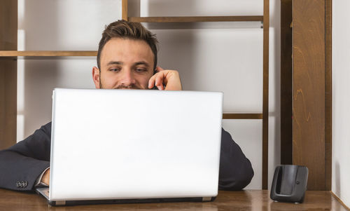 Portrait of man using laptop