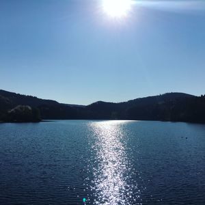 Scenic view of lake against sky on sunny day