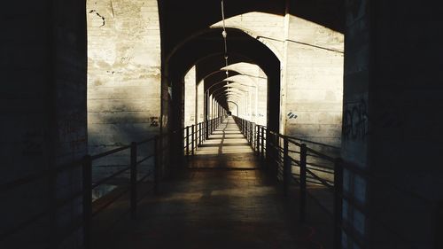 Narrow footbridge along pillars in row