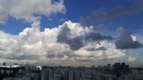 Cityscape against cloudy sky