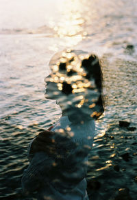 Double exposure of woman and sea