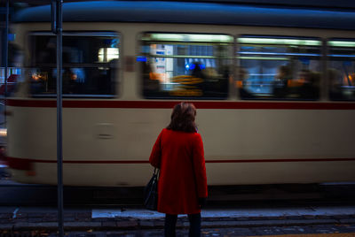 Rear view of woman on train at railroad station
