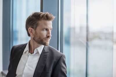 Portrait of businessman looking out of the window