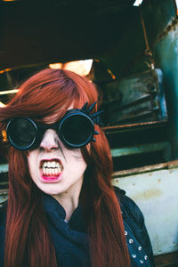 Aggressive woman wearing sunglasses outdoors