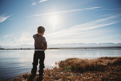 Rear view of man standing on beach