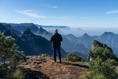 Man standing on mountain against sky