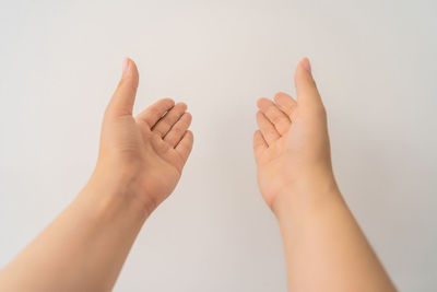 Close-up of hands against white background