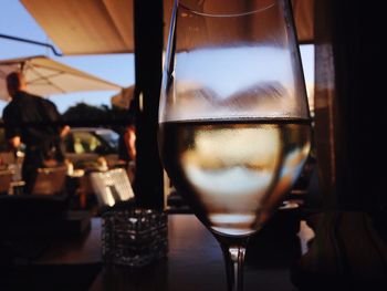 Close-up of white wine glass on table at restaurant