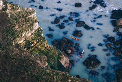 High angle view of cliff by sea