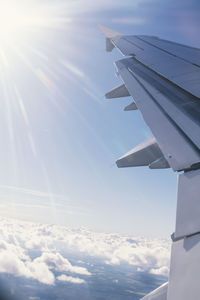 Close-up of airplane wing against sky