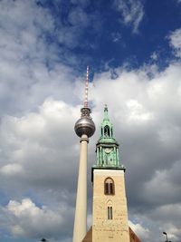 Tower against cloudy sky