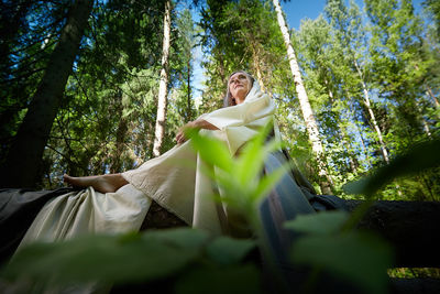 Rear view of woman sitting on hammock