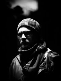 Close-up of man wearing scarf and hat in darkroom