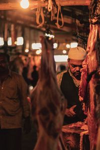 People at illuminated market stall