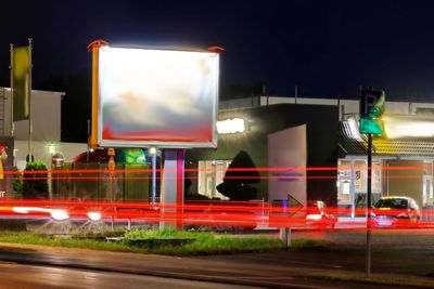 Light trails on road in city at night