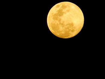 Low angle view of moon against clear sky at night