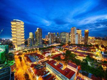 High angle view of city lit up at night