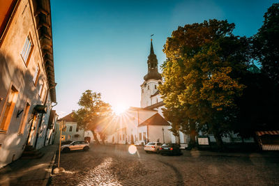 Street amidst buildings in city against sky