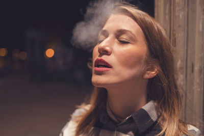 Close-up of woman smoking cigarette