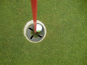 High angle view of golf ball in hole