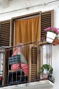 Low angle view of potted plants against building