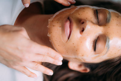 Woman with skincare face mask in beauty salon