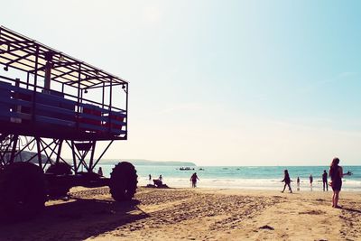 People on beach against sky
