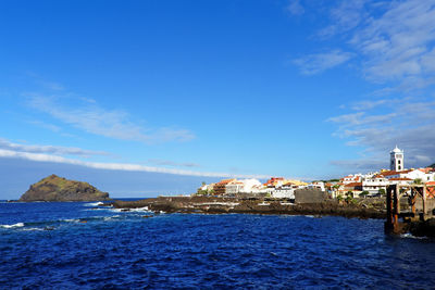 Garachico district by sea against sky at tenerife island