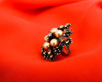 Close up of ring against red background
