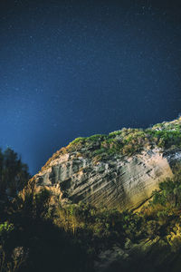 Low angle view of mountain against sky at night