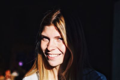 Close-up portrait of smiling young woman