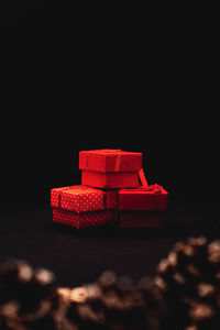 Close-up of red toy on table against black background