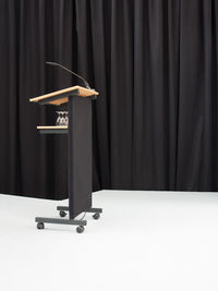 Podium with microphone against curtain