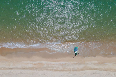 Rear view of man walking on beach