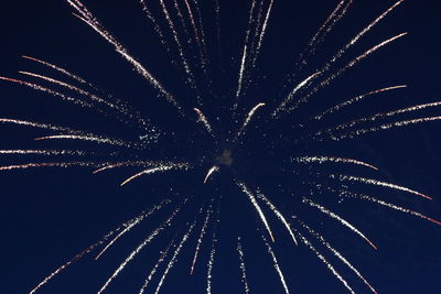 Low angle view of firework display at night