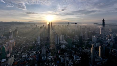 Panoramic view of city against sky during sunset