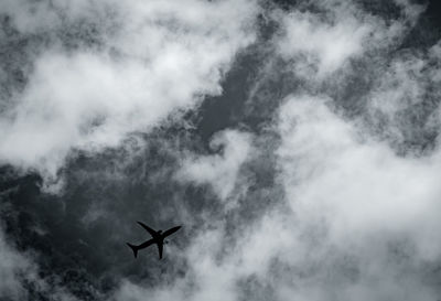 Commercial airplane on grey sky and clouds with copy space. failed vacation. hopeless and despair.