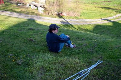 High angle view of woman sitting on grassy field