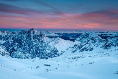 Scenic view of snowcapped mountains against sky during sunset