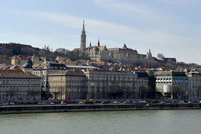 River amidst buildings against sky in city