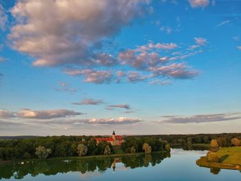 Scenic view of lake by building against sky