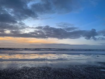 Scenic view of beach against sky during sunset